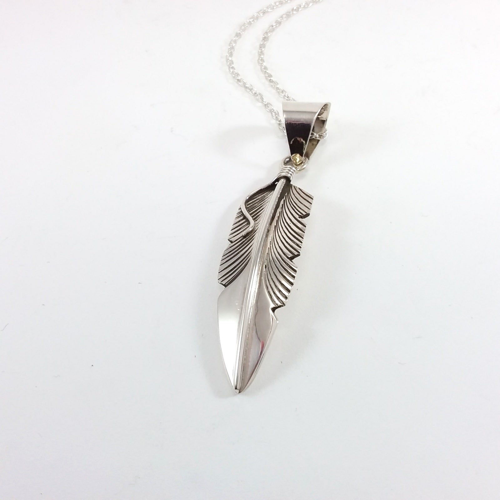 Navajo sterling silver feather pendant.