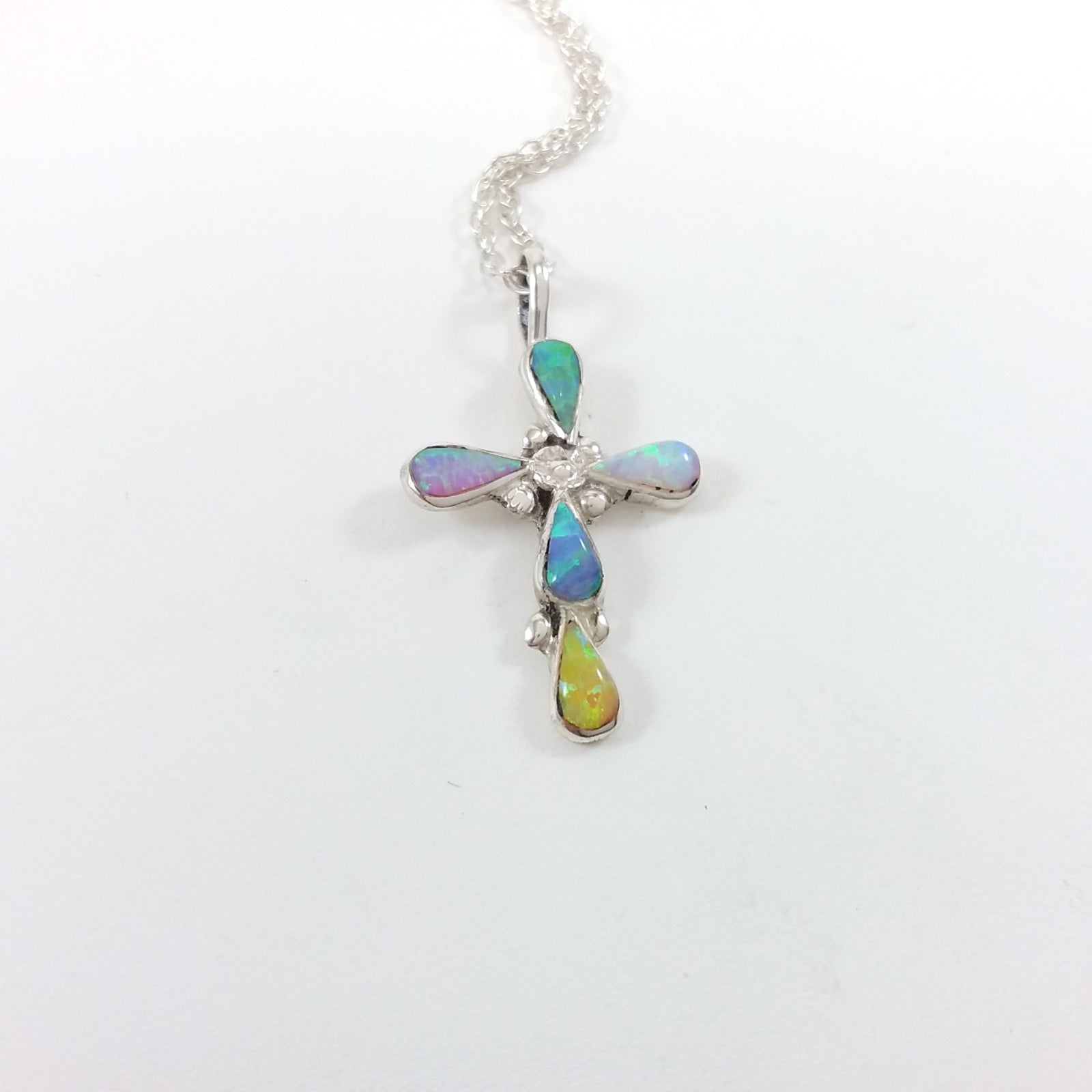 Navajo multi colored opal sterling silver cross pendant.